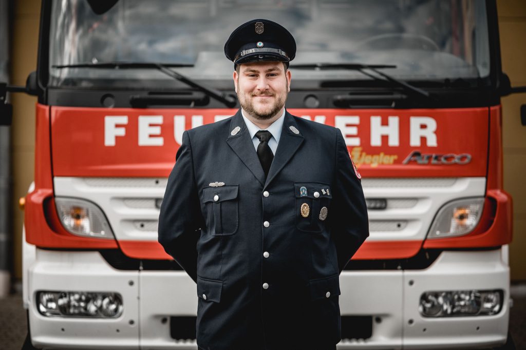 Alexander Wagner, Jugendwart FF Eibelstadt vor Feuerwehrfahrzeug HLF